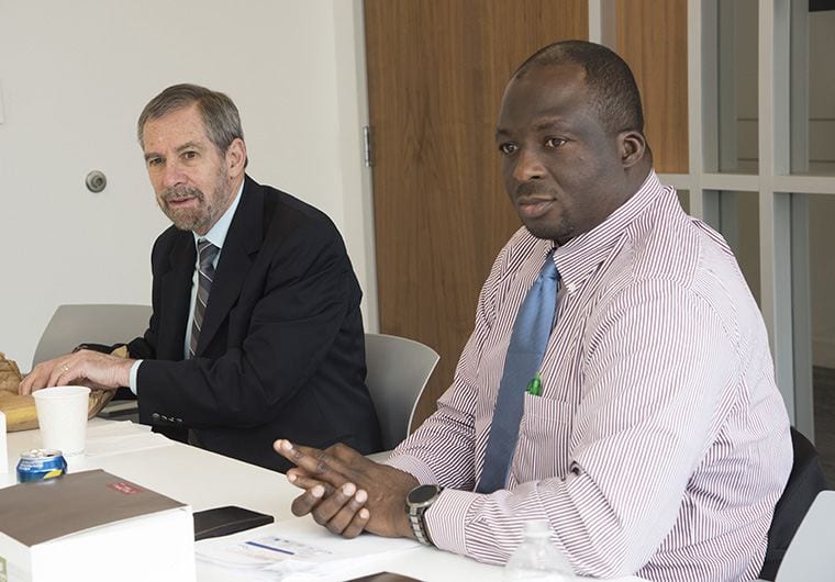 Dr. Adetunji Toriola (right) meets with a work group with acting NCI director, Dr. Doug Lowy (left).