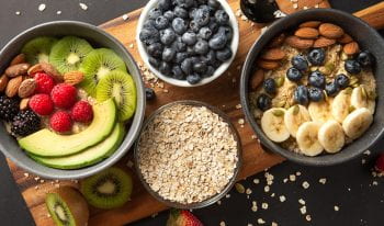A colorful assortment of fruits and oats displayed in bowls, creating a vibrant and healthy snack option.